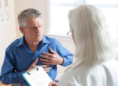 Cancer patient speaking to doctor about chest pain