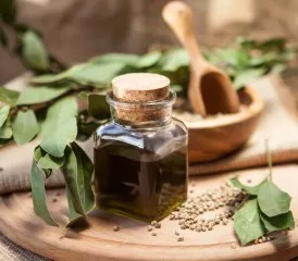 Oil in a vial with plants on a table Oil in a vial with plants on a table