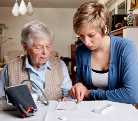 Caregiver helping patient with medicine Caregiver helping patient with medicine