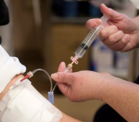 Nurse administering IV drug