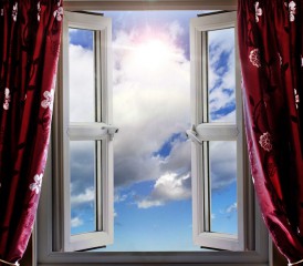 Window with curtains opening up to the sun Window with curtains opening up to the sun