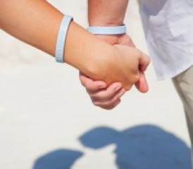 Holding hands with awareness wristbands Holding hands with awareness wristbands