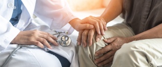 Doctor holding patient's hand