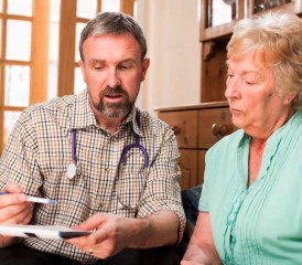 Doctor consults patient at home Doctor consults patient at home