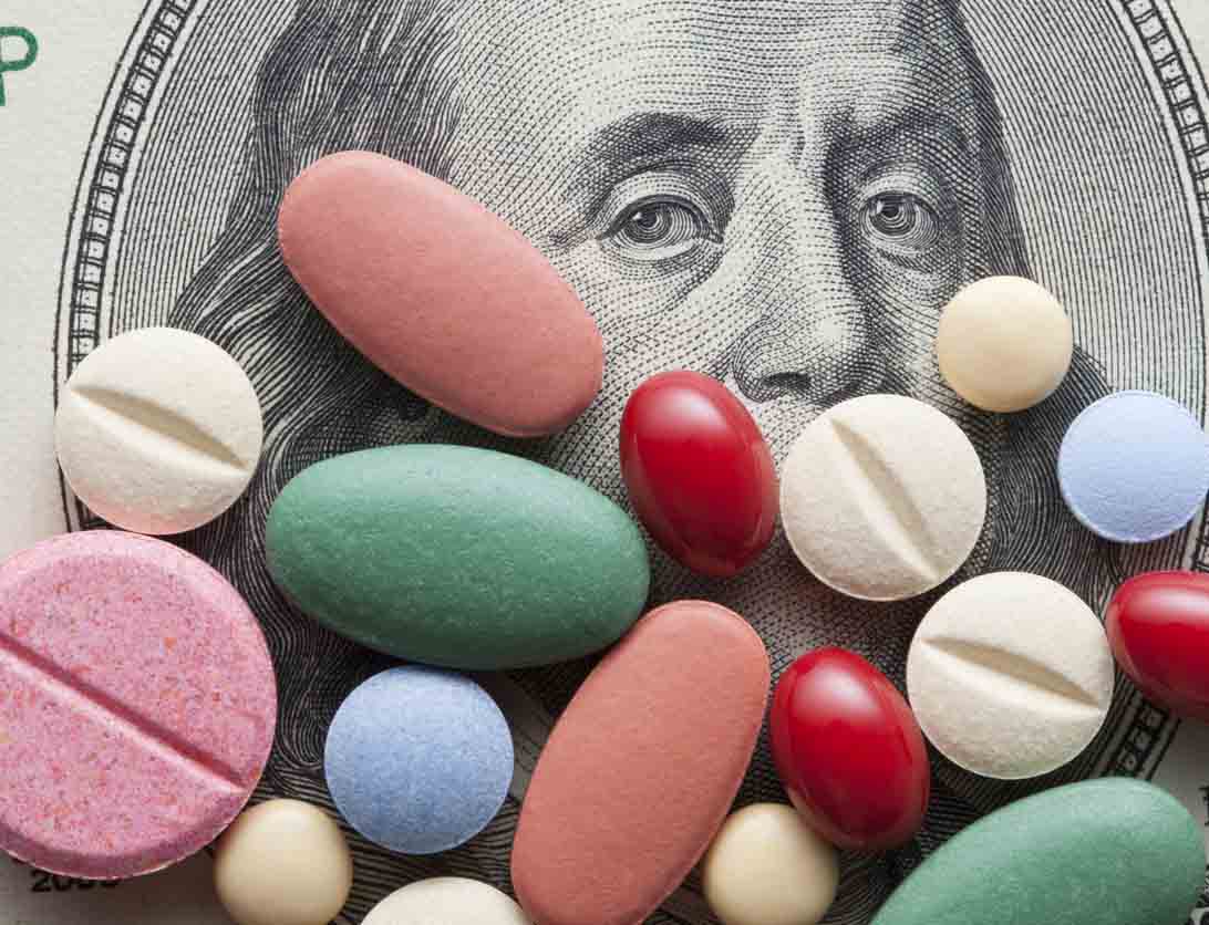 Pills on dollar bill Pills on dollar bill