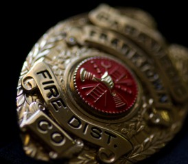 Firefighter badge on a black background Firefighter badge on a black background
