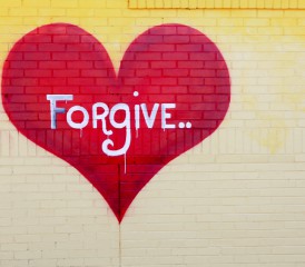 Red heart labeled with forgiveness and painted on a wall Red heart labeled with forgiveness and painted on a wall