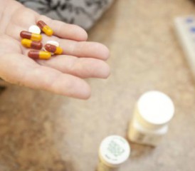 A person holding pills A person holding pills