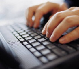 Person typing on a keyboard