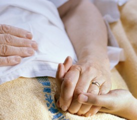 Two people holding hands with wedding rings Two people holding hands with wedding rings