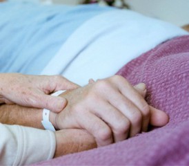 Person Holding Hospital Patient's Hand Person Holding Hospital Patient's Hand