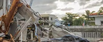 Excavator clearing debris following a hurricane
