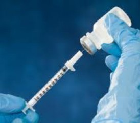 Gloved hands taking sample with a syringe Gloved hands taking sample with a syringe