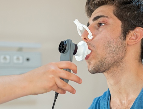Doctor checking patient's lung capacity Doctor checking patient's lung capacity