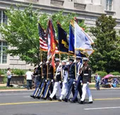 Servicemen of the National Guard marching holding flags