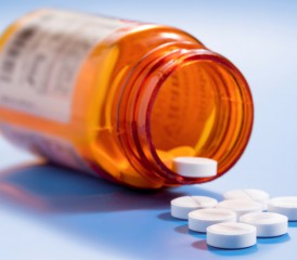 Open pill bottle with pills Open pill bottle with pills