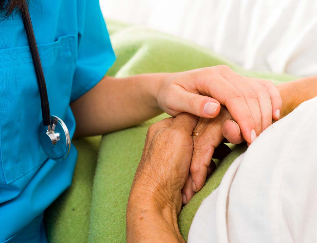 Nurse holding a patient's hands Nurse holding a patient's hands