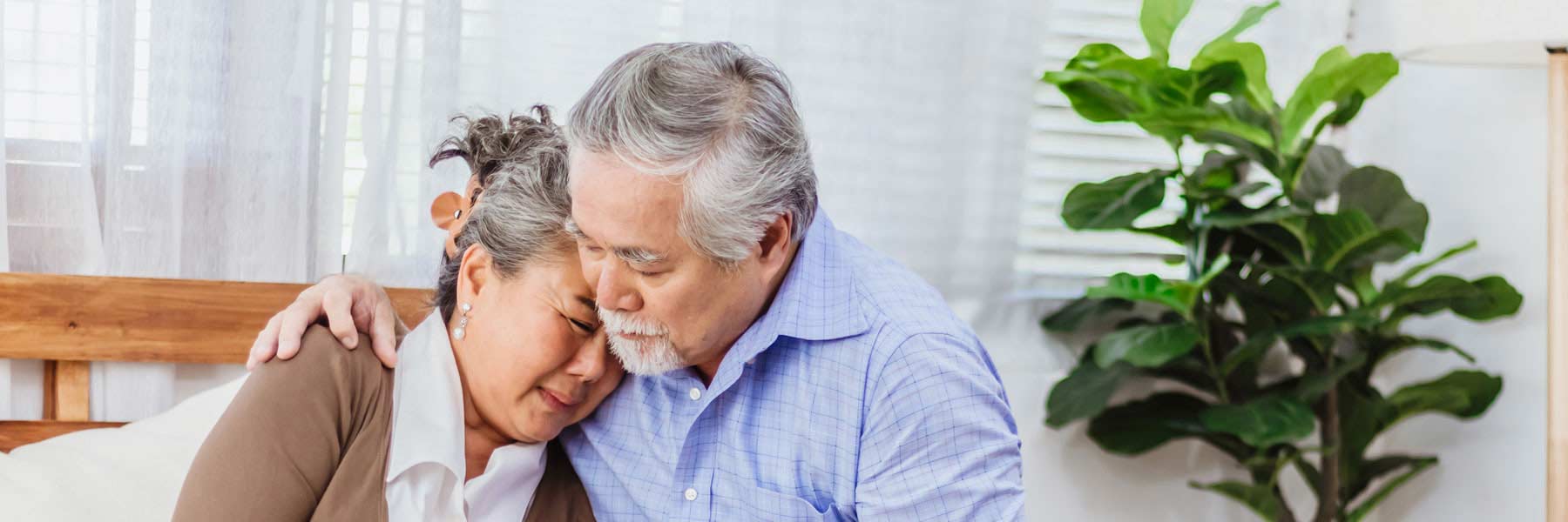 Older man comforting his wife