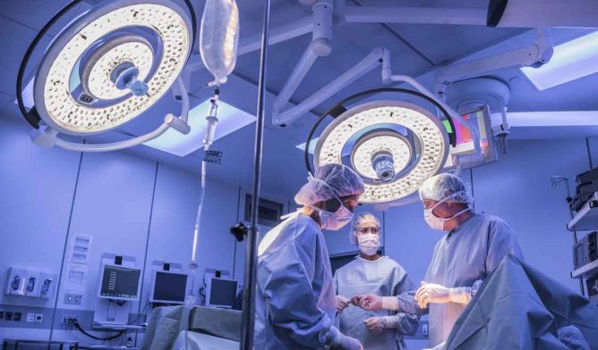 Surgeons operating on patient