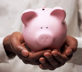 Hands Holding a Piggy Bank Hands Holding a Piggy Bank