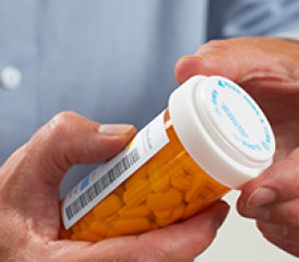 Man holding pill bottle Man holding pill bottle