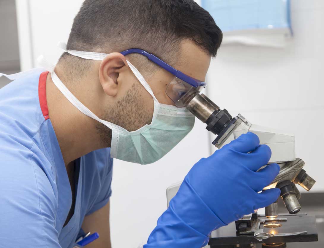 Researcher using microscope Researcher using microscope