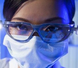 Asian female researcher with glasses and mask over mouth Asian female researcher with glasses and mask over mouth