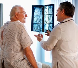 Doctor shows patient CT scans Doctor shows patient CT scans