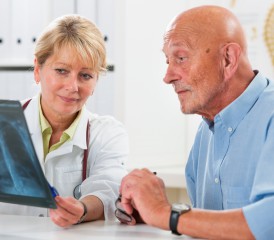 Female doctor explains X-ray to male patient Female doctor explains X-ray to male patient