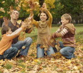 Family Playing in Fall Leaves Family Playing in Fall Leaves