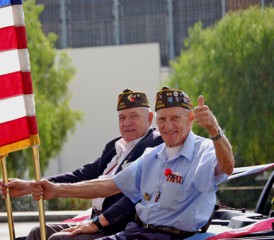 U.S military veterans riding in the back of a car U.S military veterans riding in the back of a car