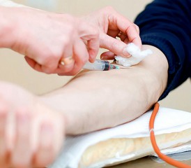 Nurse taking blood from patient
