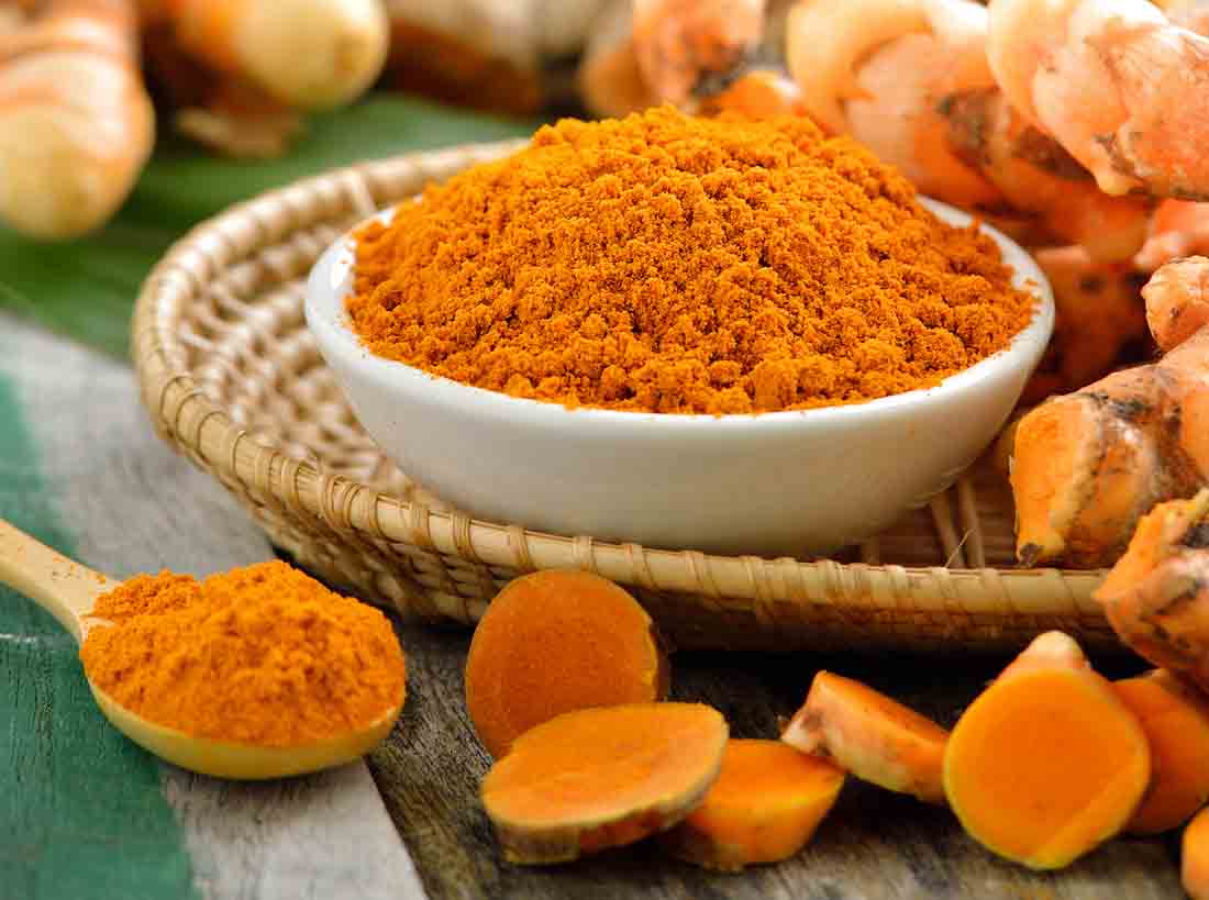 turmeric roots in the basket on wooden table turmeric roots in the basket on wooden table