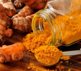 Turmeric root and powder on wood. Turmeric root and powder on wood.