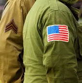 Side of two U.S. military uniforms from World War II (WWII).