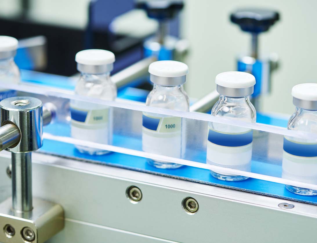 Drug vials in assembly line Drug vials in assembly line