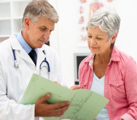 Woman speaks with male doctor Woman speaks with male doctor