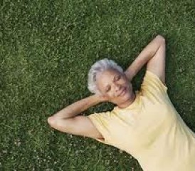Woman relaxing on a patch of grassy Woman relaxing on a patch of grassy