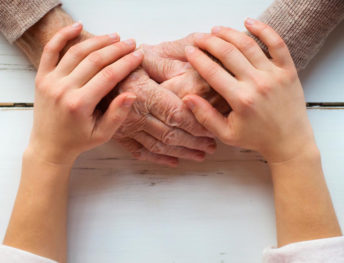 Young hands holding older hands Young hands holding older hands